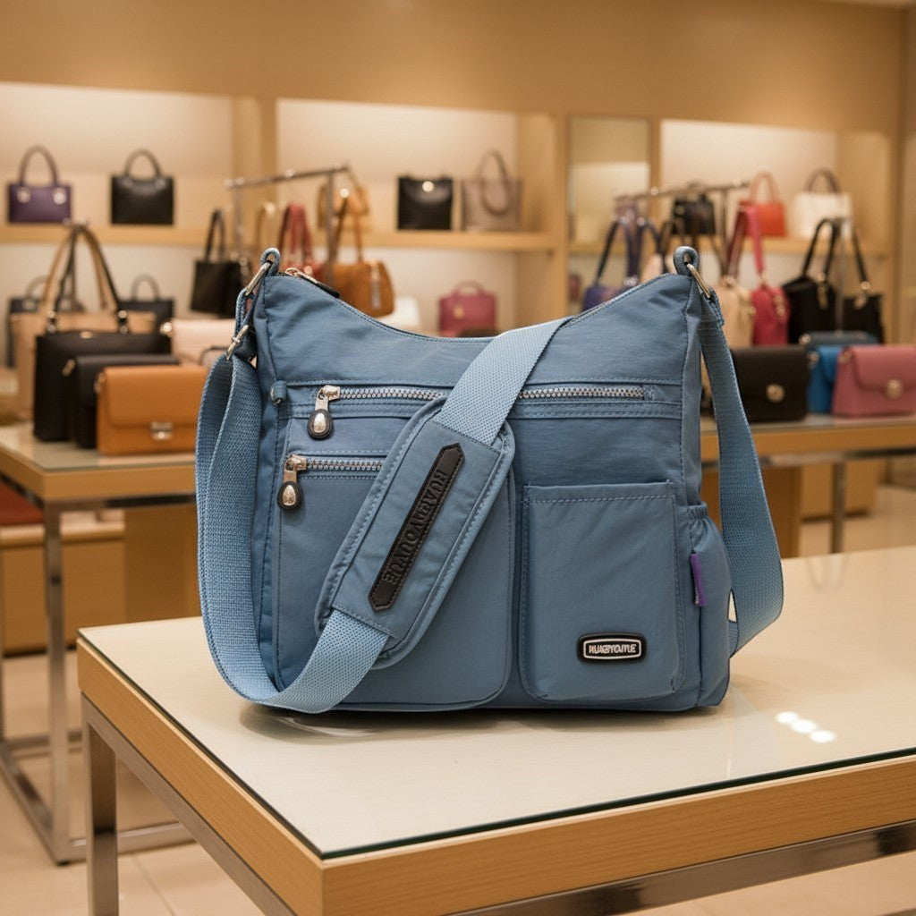 ZenZon Nordic blue nylon crossbody bag with multiple zippered pockets and an adjustable shoulder strap in a store