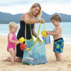 ZenZon Nordic green mesh beach bag for toys held by a woman on a sunny beach with two children playing